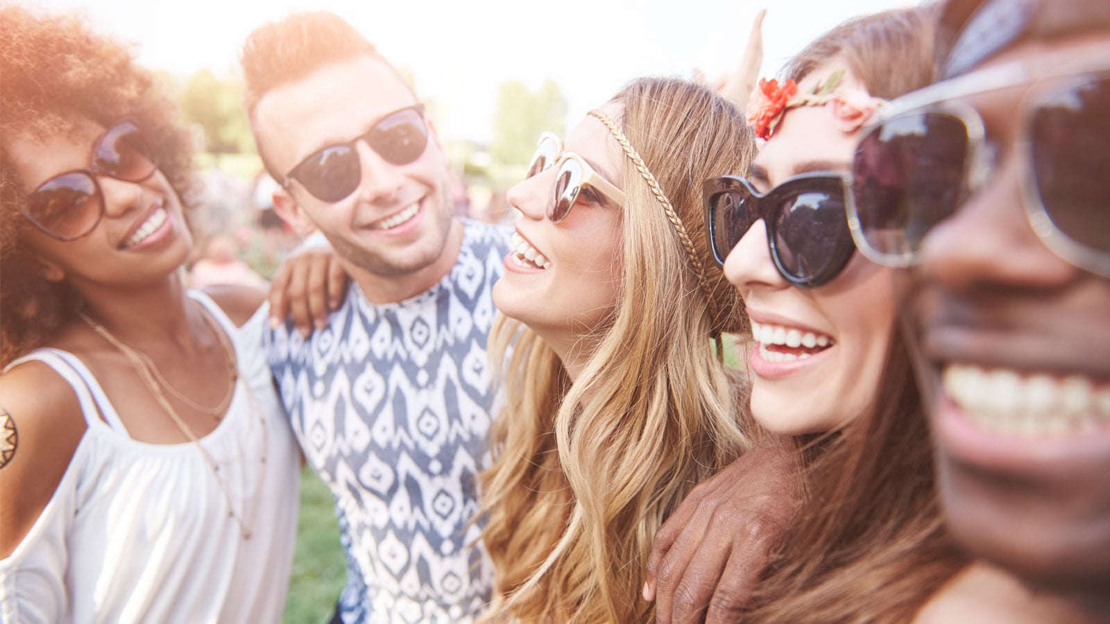 A group of people smiling in the sunshine