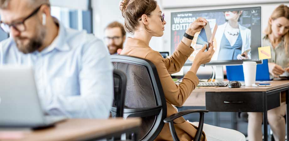 web-design-cost4 People in an office designing websites